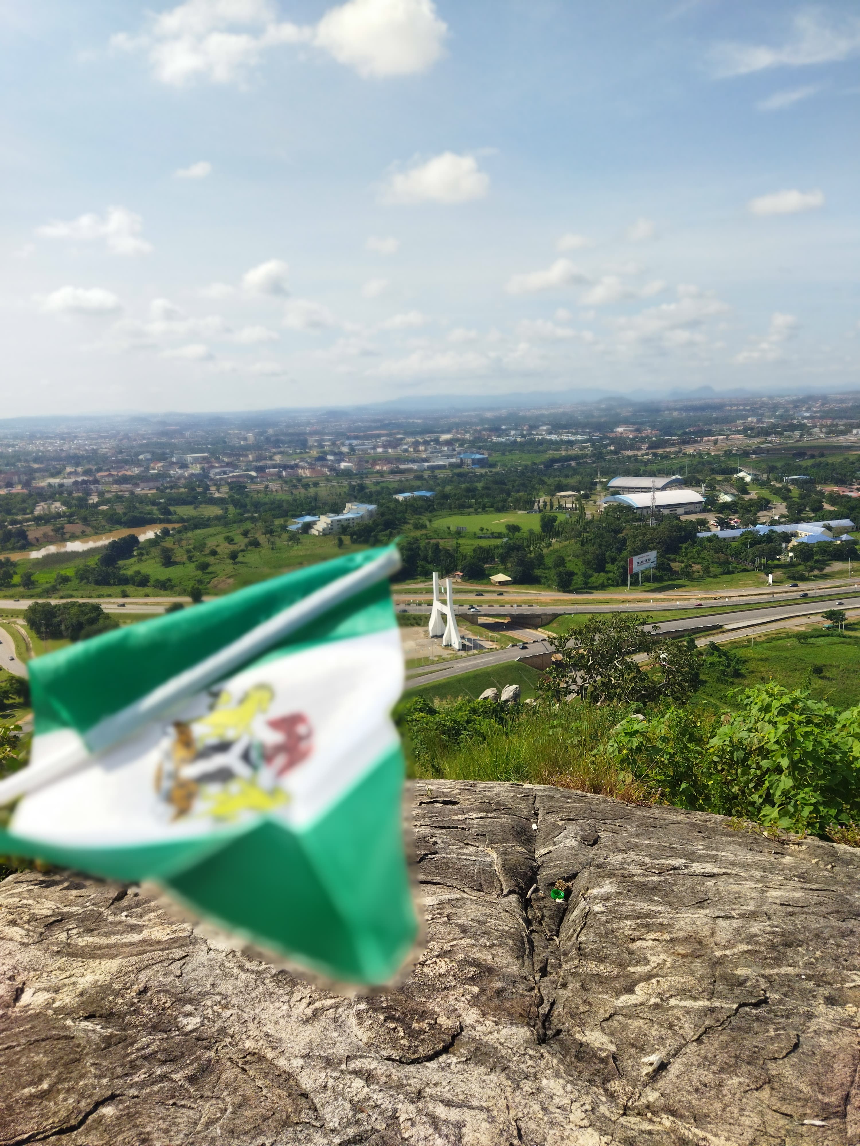 The Abuja City Gate flying the Nigerian flag